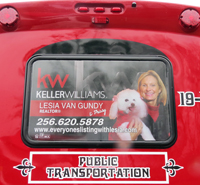 CARTS Bus Window Advertisement for Keller Williams Realtor Lesia Van Gundy holding puppy and business information
